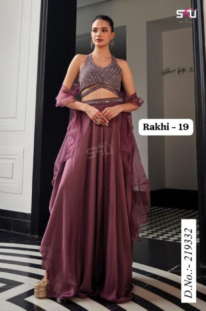Elegant woman wearing a mauve-purple designer lehenga set with sequin halter top, flowy georgette skirt, and sheer dupatta, posing indoors.